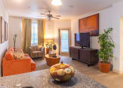 Thumbnail 22 of 49 - a living room filled with furniture and a flat screen tv
