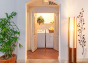 Thumbnail 43 of 49 - a small laundry room with a washer and dryer