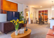 Thumbnail 24 of 49 - a living room with a tv and a dining room in the background