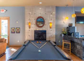 Thumbnail 16 of 49 - a pool table in front of a fireplace in a living room