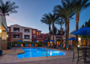 Thumbnail 2 of 49 - a resort style swimming pool with lounge chairs and umbrellas
