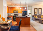 Thumbnail 40 of 49 - a kitchen and living room with a table and chairs