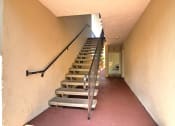Thumbnail 3 of 31 - a set of stairs leading up to a hallway with a railing