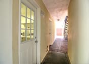 Thumbnail 4 of 31 - a hallway with a white door and a staircase in a building