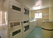 Thumbnail 15 of 30 - A row of white ovens are lined up in a room.