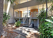 Thumbnail 8 of 30 - A house with a balcony and stairs leading to it.