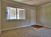 Thumbnail 5 of 22 - an empty living room with a window and a door