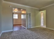 Thumbnail 6 of 22 - an empty living room with an open door to a bedroom
