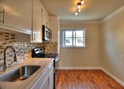 Thumbnail 8 of 22 - an empty kitchen with a sink and a window