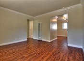 Thumbnail 13 of 22 - an empty living room with wood flooring and a closet