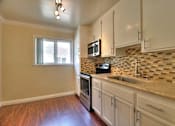 Thumbnail 14 of 22 - a kitchen with white cabinets and a counter top