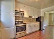 Thumbnail 15 of 22 - a kitchen with stainless steel appliances and white cabinets