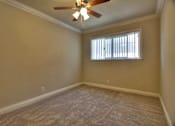 Thumbnail 17 of 22 - an empty living room with a ceiling fan and a window