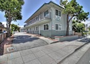 Thumbnail 1 of 15 - A street view of a building with the sign