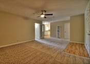 Thumbnail 9 of 21 - Empty room with a ceiling fan and carpeted floor.