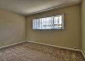 Thumbnail 13 of 21 - A room with a window covered by white blinds.