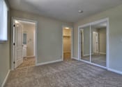 Thumbnail 16 of 21 - A room with a carpeted floor and a white door.