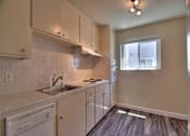 Thumbnail 13 of 21 - a kitchen with white cabinets and a sink and a window