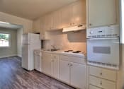 Thumbnail 14 of 21 - an empty kitchen with white cabinets and a refrigerator