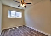Thumbnail 15 of 21 - an empty living room with a ceiling fan and a window