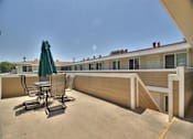 Thumbnail 9 of 21 - the patio has a table and chairs and an umbrella