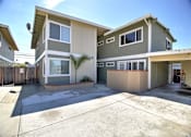 Thumbnail 1 of 26 - the front of the building with a driveway and a parking lot
