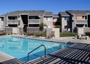 Thumbnail 12 of 22 - Pool Side Relaxing Area at Park West Apartments, Chino, California