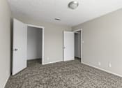 Thumbnail 10 of 47 - A room with carpeted floor and two doors.