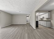 Thumbnail 15 of 47 - A room with light wood flooring and white walls.