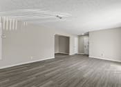 Thumbnail 12 of 47 - A room with wooden flooring and white walls.