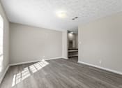 Thumbnail 13 of 47 - A room with light wood flooring and white walls.