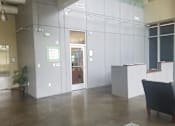 Thumbnail 3 of 16 - A black chair is in front of a white cubicle.