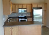 Thumbnail 6 of 13 - Fully Equipped Kitchen at The Pines Townhomes, North Dakota