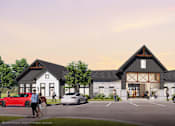 Thumbnail 3 of 12 - A building with a triangular roof and a sign that reads "Dynamik Design" is surrounded by parked cars.
