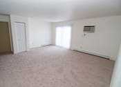Thumbnail 17 of 18 - Living room at Whispering Pines Apartments in Holland, Michigan