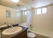 Thumbnail 9 of 9 - a bathroom with a sink and a tub and a mirror