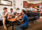 Thumbnail 8 of 19 - a group of people sitting in a living room playing a video game