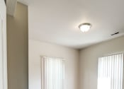 Thumbnail 11 of 19 - an empty living room with two windows and a door