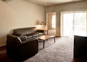 Thumbnail 15 of 19 - an empty living room with a couch and a table