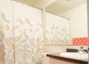 Thumbnail 13 of 17 - a bathroom with a toilet and a sink and a shower curtain