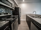Thumbnail 13 of 21 - Kitchen with Breakfast Bar at Mesh Properties, Austin, Texas