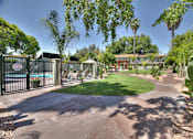 Thumbnail 17 of 17 - A gated community with a pool and a green lawn.
