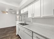 Thumbnail 15 of 24 - kitchen with white cabinets and a sink