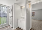 Thumbnail 17 of 24 - renovated bathroom with a washer and dryer