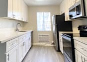 Thumbnail 17 of 46 - kitchen with stove, sink and fridge