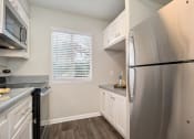 Thumbnail 18 of 40 - Fridge In Kitchen at St. Charles Oaks Apartments, Thousand Oaks, California