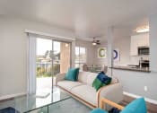 Thumbnail 38 of 67 - Glass Door, Sofa In Living Room at Los Robles Apartments, Pasadena, CA