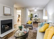 Thumbnail 17 of 21 - Living Room with Ceiling Fan, Fireplace, Wood-Style Floors, and View of Dining Room at Aliso Creek, Aliso Viejo, 92656
