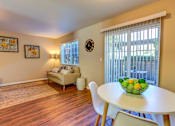 Thumbnail 14 of 31 - Living room with table at Commons at Hawthorn Village Apartments, Oregon, 97124