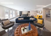 Thumbnail 12 of 24 - Spacious renovated clubhouse lounge with modern furniture and warm lighting